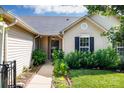 Inviting entrance of home with lovely landscaping leading to front door at 5806 Autumn Trace Ln, Indian Trail, NC 28079