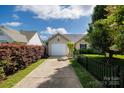 Beautiful home with a well-manicured lawn and driveway leading to a garage at 5806 Autumn Trace Ln, Indian Trail, NC 28079