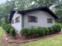 Charming painted brick home featuring wood shutters at 605 Impala Dr, Albemarle, NC 28001