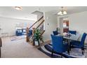Inviting dining room with a glass table, comfortable blue chairs, and stylish decor at 7136 Bullock Dr, Charlotte, NC 28214