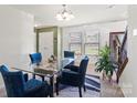 Inviting dining room with a glass table, comfortable blue chairs, and stylish decor at 7136 Bullock Dr, Charlotte, NC 28214