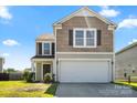 Charming two-story home with neutral siding, an attached garage, and a well-maintained lawn at 7136 Bullock Dr, Charlotte, NC 28214