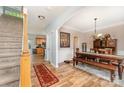 A dining room features hardwood floors, a rustic wooden table with bench seating, and decorative accents at 7218 Cascading Pines Dr, Fort Mill, SC 29708