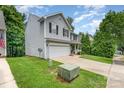 An eye-level shot of a two-story home with light siding and a green lawn, showcasing the side of the property at 7218 Cascading Pines Dr, Fort Mill, SC 29708
