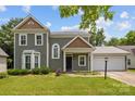 Inviting two-story home with a well-kept lawn, neatly trimmed bushes, and a two car garage at 9121 Four Acre Ct, Charlotte, NC 28210