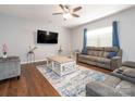 Cozy living room with hardwood floors, a ceiling fan, and comfortable seating area for relaxing or entertaining at 9123 Magnolia Lily Ave, Charlotte, NC 28227