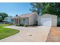Well-maintained home with a detached garage and long driveway at 1005 Noles Dr, Mount Holly, NC 28120