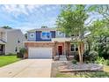 Charming two-story home featuring a stone facade, a front porch, and a two-car garage at 10304 Ebbets Rd, Charlotte, NC 28273