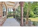 Covered front porch featuring stone pillars and black wrought iron railings at 10304 Ebbets Rd, Charlotte, NC 28273