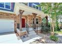 Covered front porch featuring stone pillars and black wrought iron railings at 10304 Ebbets Rd, Charlotte, NC 28273