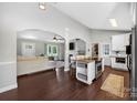 Open floor plan showcasing kitchen with island and adjacent living room with hardwood floors at 106 Abbey Cir, Salisbury, NC 28147