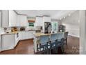 Bright kitchen with granite countertops, white cabinets, and island seating at 106 Abbey Cir, Salisbury, NC 28147