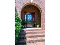Elegant brick entryway with glass-paneled door and potted plants at 1083 Fox Chase Dr, Newton, NC 28658