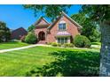 Beautiful brick home with arched entryway and well-maintained lawn at 1083 Fox Chase Dr, Newton, NC 28658