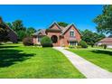 Charming brick home with a manicured lawn and mature landscaping at 1083 Fox Chase Dr, Newton, NC 28658