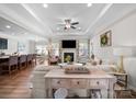 Open-concept living room featuring tray ceilings, a fireplace, and seamless flow to the kitchen and dining area at 117 Autumn Mist Rd, Statesville, NC 28677