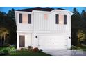 Charming two-story home featuring white siding, black shutters, and a two-car garage at 1358 31St St, Conover, NC 28613