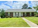 Charming single-story home featuring a well-maintained lawn, brick accents, and a welcoming front entrance at 1901 Taylor Dr, Gastonia, NC 28052