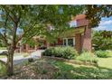 Inviting brick home with a cozy front porch and lush landscaping at 206 Mitchell Ave, Salisbury, NC 28144