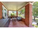 Relaxing covered porch with comfortable seating and classic brick columns at 206 Mitchell Ave, Salisbury, NC 28144
