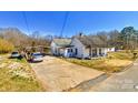 Exterior view of a traditional home with a long driveway and covered parking at 211 Oak Dr, Shelby, NC 28150