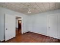 Bedroom featuring hardwood floors, neutral paint, and two closets at 226 S Morrow Ave, Albemarle, NC 28001