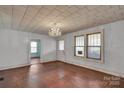 Spacious living room featuring hardwood floors, a decorative chandelier, and natural light at 226 S Morrow Ave, Albemarle, NC 28001