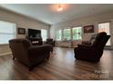 Open-concept living room featuring luxury vinyl plank flooring, neutral paint, and ample natural light at 284 Old Harbor Dr, Mount Gilead, NC 27306