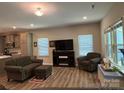 Inviting living room featuring luxury vinyl plank flooring, neutral paint, and great natural light at 284 Old Harbor Dr, Mount Gilead, NC 27306