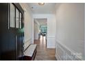 Bright entryway featuring hardwood floors, elegant molding, and a clear view into the living area at 336 Secretariat Dr, Iron Station, NC 28080