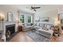 Comfortable living room with a fireplace, large windows, and hardwood flooring at 336 Secretariat Dr, Iron Station, NC 28080
