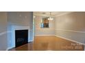 Bright living room boasting hardwood floors and a cozy fireplace at 3549 Calpella Ct, Charlotte, NC 28262