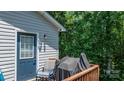 View of the wood deck, accessible from the home's rear, featuring a grill, a chair, and an exterior door at 431 Forest Dr, Maiden, NC 28650
