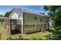 View of the home's rear exterior, showing the deck, siding, basement foundation, and yard space at 431 Forest Dr, Maiden, NC 28650