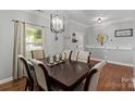 A dining room with dark wood floors, table, and decor at 4408 Overbecks Ln, Waxhaw, NC 28173