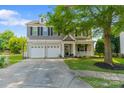 Charming two-story home featuring a well-manicured lawn, two-car garage, and inviting front porch at 4408 Overbecks Ln, Waxhaw, NC 28173
