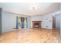Living room with a brick fireplace and large windows that fill the room with natural light at 495 Brumley Rd, Mooresville, NC 28115