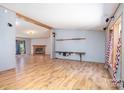 Open-concept living room featuring wood floors and a brick fireplace at 495 Brumley Rd, Mooresville, NC 28115