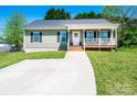Inviting home showcasing a tidy front yard and cozy covered porch, perfect for relaxing at 50 Serenity Ln, Hickory, NC 28601