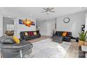Cozy living room featuring modern furnishings, a ceiling fan, and neutral paint colors with natural light at 5822 Parkstone Dr, Matthews, NC 28104