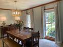 Dining room with large windows, wooden table, and ample natural light at 6632 Summer Darby Ln, Charlotte, NC 28270