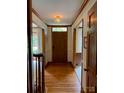 Hallway featuring hardwood flooring, trim and a stylish light fixture at 6632 Summer Darby Ln, Charlotte, NC 28270