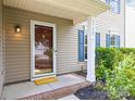 Inviting front entrance featuring a decorative door, column, a yellow doormat, and well-maintained landscaping at 6720 Long Nook Ln, Indian Trail, NC 28079