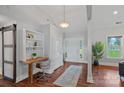Bright entryway with hardwood floors, built-in desk, and large windows showcasing natural light at 7478 Pine Ridge Dr, Denver, NC 28037