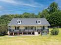 Lovely home with a welcoming front porch, perfect for enjoying the scenic views and tranquil surroundings at 814 Carved Oak Ct, York, SC 29745