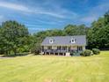 Beautiful home boasting a charming front porch and well-maintained lawn, nestled among mature trees and greenery at 814 Carved Oak Ct, York, SC 29745