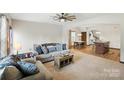 Spacious living area featuring open layout to kitchen and dining with neutral tones and comfortable seating at 8152 Chilkoot Ln, Locust, NC 28097