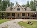 Inviting home showcasing a long covered porch and an oversized driveway at 820 King Rd, Clover, SC 29710