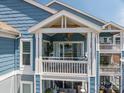 Charming balcony with white railing, offering a view of the surrounding lake and natural light at 1018 Southwest Sw Dr # 18, Davidson, NC 28036