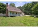 Beautiful home featuring a covered front porch, lush lawn, and a spacious two-car garage at 10206 Washam Potts Rd, Cornelius, NC 28031